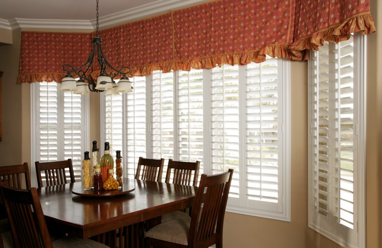 Shutters on wide kitchen windows